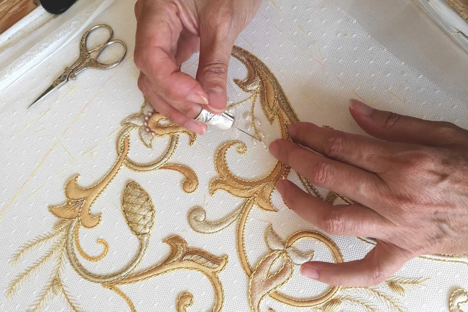 La labor de los bordados en Castilla-La Mancha cuenta con una tradición ancestral. Aunque es sólo a partir del siglo XVI cuando se tienen referencias documentales, se cree que toda la tradición de estas delicadas labores textiles hunde sus raíces en el medievo. Y desde entonces, se ha ido traspasando de generación en generación, principalmente a través de las mujeres: de madres a hijas.<br />
A pesar de los profundos cambios sociales y culturales, acentuados principalmente en el siglo XX, Castilla-La Mancha ha sabido preservar su legado artesano también en lo que concierne al bordado, y aún hoy se conserva esta tradición que tiene como fruto diseños exclusivos.<br />
En el stand de España en EXPO OSAKA 2025 participa, en la semana de Castilla-La Mancha, la artesana Macarena Sanz, de Cuenca, que elabora todo tipo de piezas que contienen como ornamentación las distintas técnicas del bordado en oro. Elabora bordados para estandartes, vestuario de imágenes religiosas y diferentes elementos de la liturgia religiosa (católicas); además de piezas de tela para banderas, enseñas y reposteros institucionales.<br />
Maestra artesana: Macarena Sanz, Cuenca.<br />
